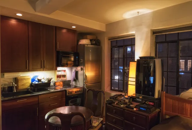 a kitchen with wooden cabinets and a stove top oven