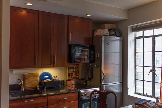 a kitchen with stainless steel appliances a refrigerator and cabinets