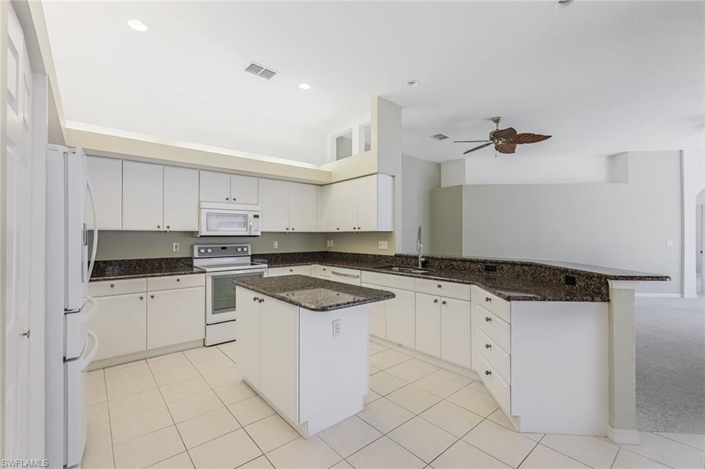 10221 Cape Roman Road, Unit 102 Estero, FL 34135 - Photo 11 of 49 Island Kitchen with Pantry & Breakfast Bar