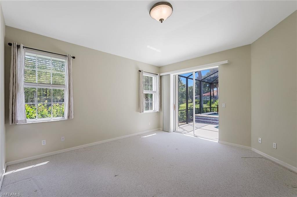 10221 Cape Roman Road, Unit 102 Estero, FL 34135 - Photo 14 of 49 Master/Primary Bedroom w/ Pool View