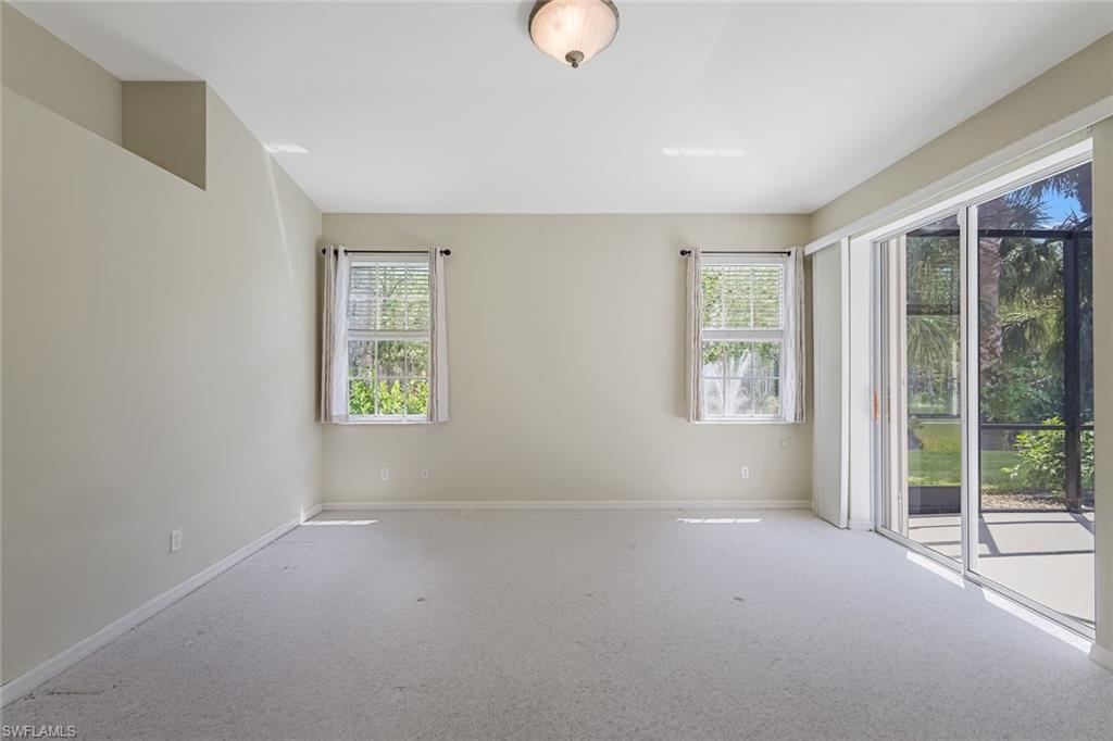 10221 Cape Roman Road, Unit 102 Estero, FL 34135 - Photo 15 of 49 Master/Primary Bedroom w/ Pool View