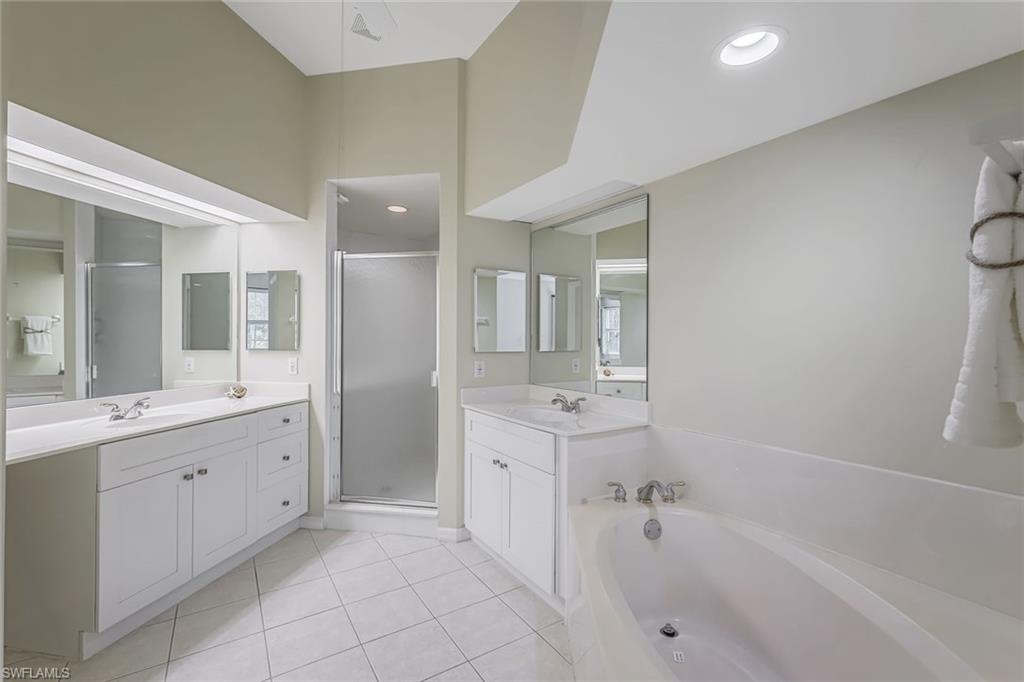 10221 Cape Roman Road, Unit 102 Estero, FL 34135 - Photo 16 of 49 Master/Primary Bath w/ Tub and Walk in Shower, Dual Sinks