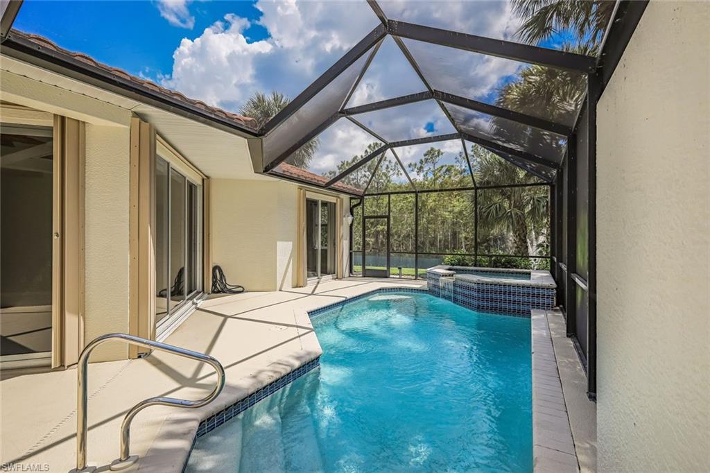 10221 Cape Roman Road, Unit 102 Estero, FL 34135 - Photo 22 of 49 Screened Lanai with Pool/Spa - Very Private Lake View with Water Feature
