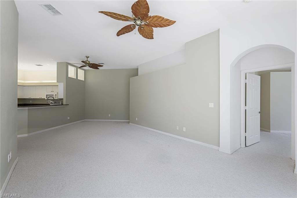 10221 Cape Roman Road, Unit 102 Estero, FL 34135 - Photo 4 of 49 Living Room/Dining - Kitchen in Distance