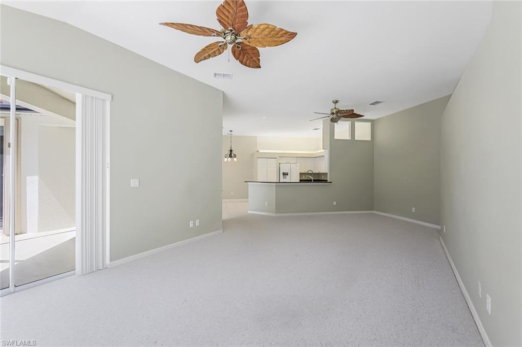 10221 Cape Roman Road, Unit 102 Estero, FL 34135 - Photo 5 of 49 Living Room - Dining & Kitchen in Distance