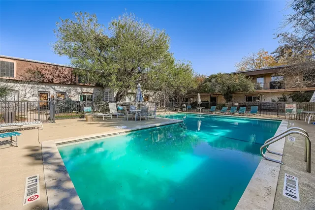 a view of a swimming pool with outdoor seating