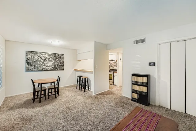 a view of a livingroom with furniture and a window