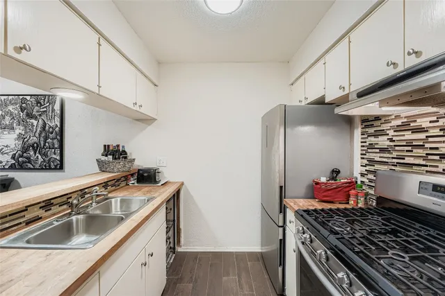 a kitchen with stainless steel appliances granite countertop a stove and a sink