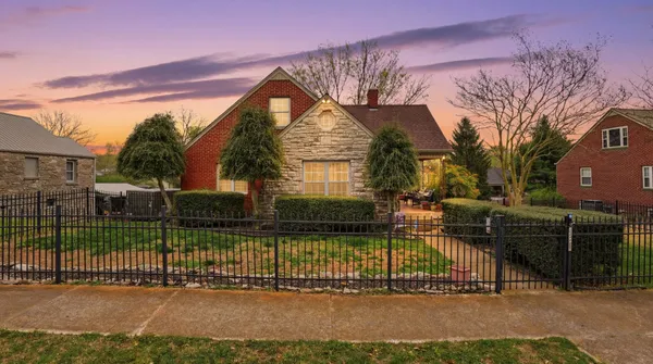 a view of a house and a yard in the background