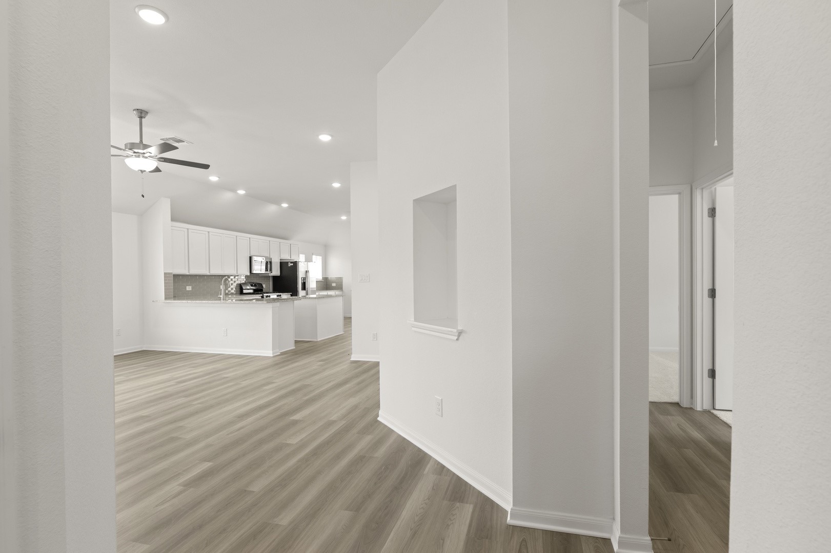 3729 Pin Oak Hills Seguin, TX 78155 - Photo 10 of 22 Unfurnished living room with light wood-style flooring, recessed lighting, a ceiling fan, and a towering ceiling