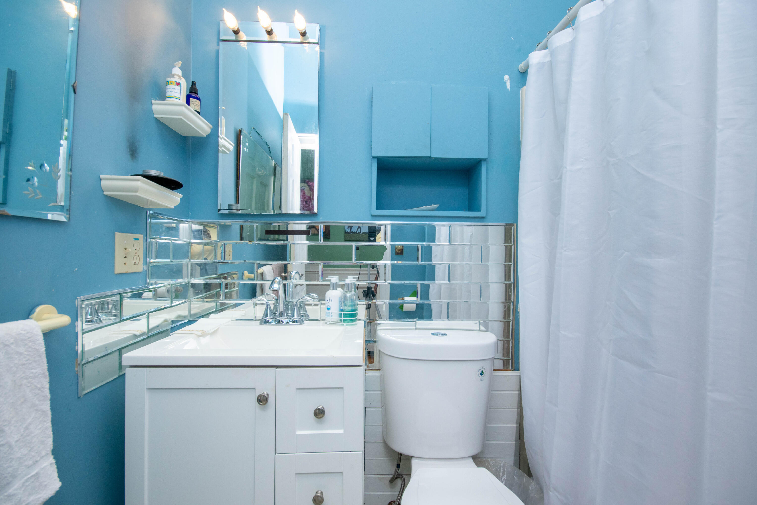 305 County Road Monument Beach, MA 02532 - Photo 22 of 34 a bathroom with a sink a toilet and mirror