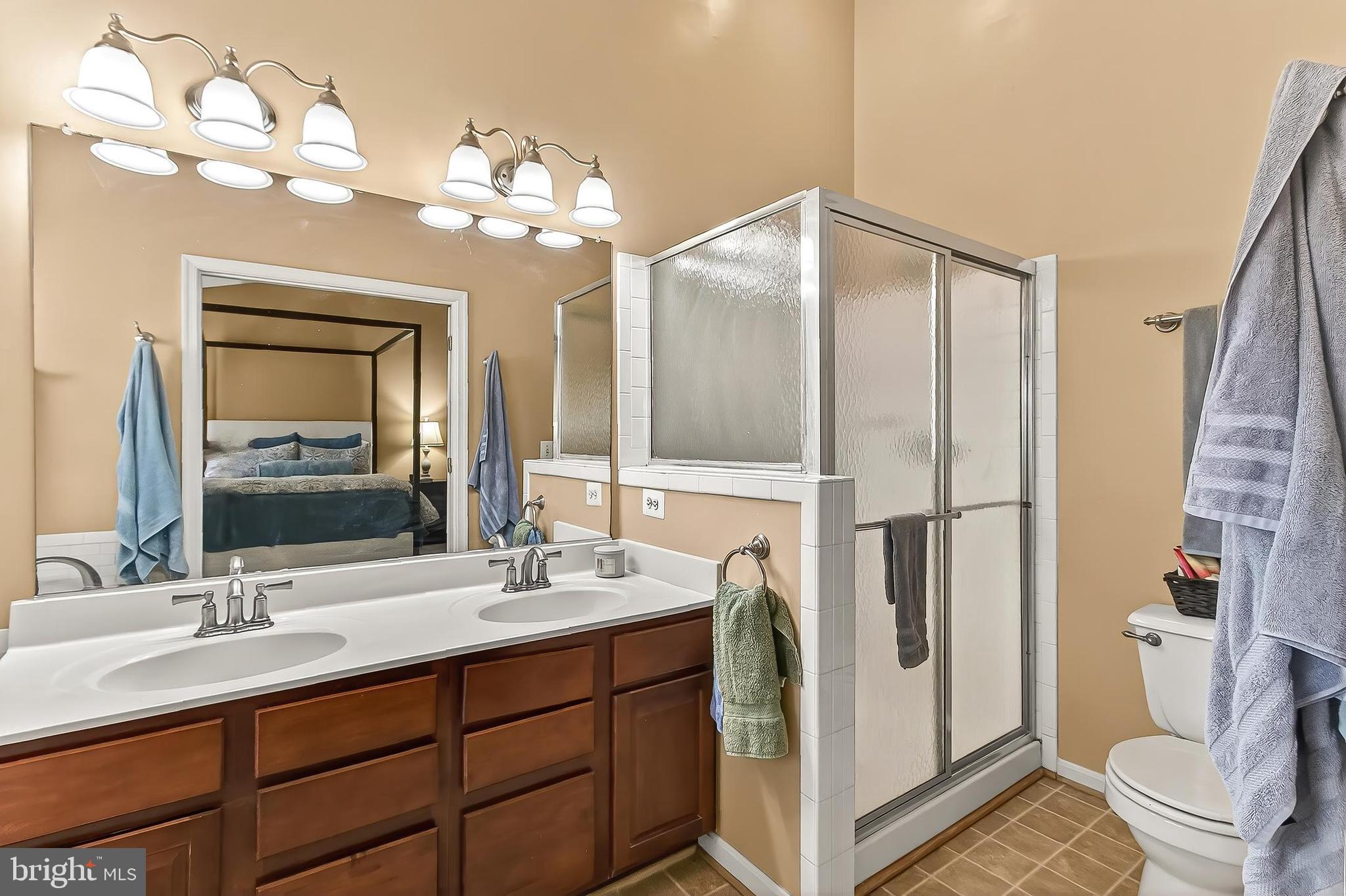 8445 Carmela Circle Springfield, VA 22153 - Photo 45 of 53 a bathroom with a double vanity sink mirror and toilet
