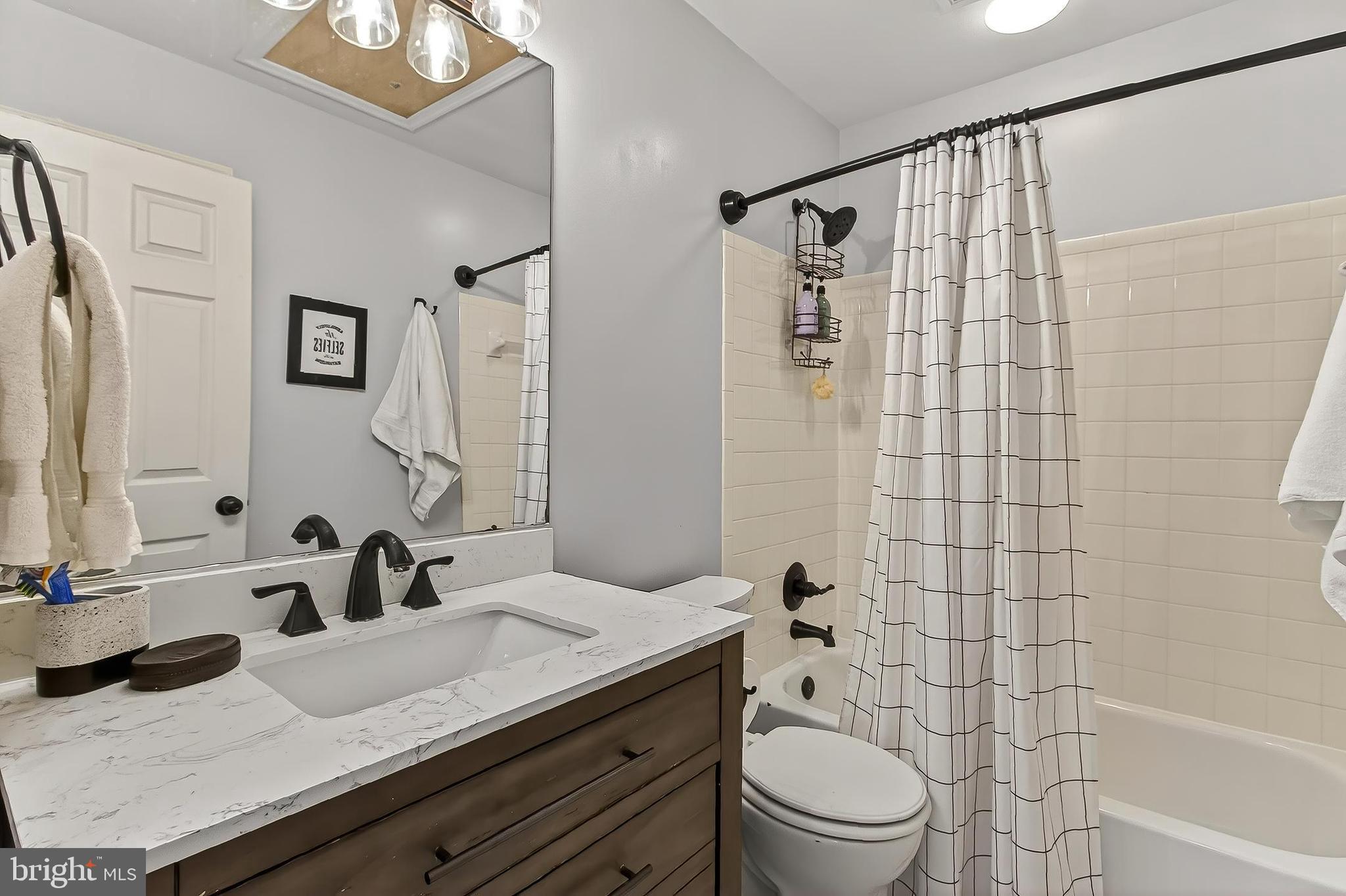 8445 Carmela Circle Springfield, VA 22153 - Photo 47 of 53 a bathroom with a granite countertop sink a toilet and shower