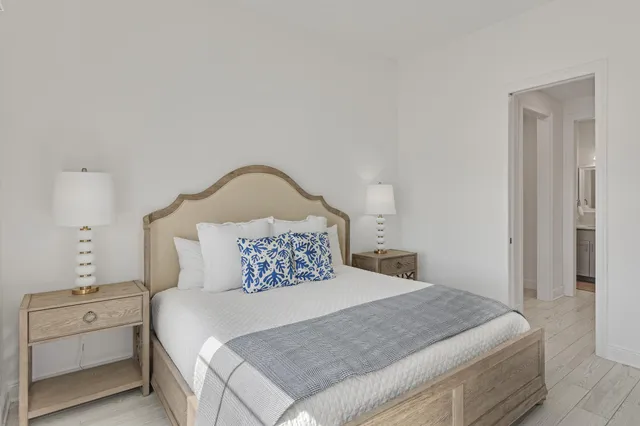 a bathroom with a sink double vanity granite tub shower and a mirror