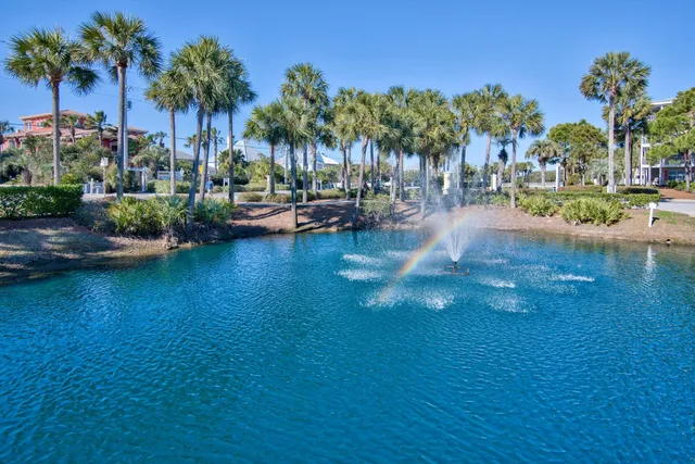 a view of road with card parked on side and retail shops