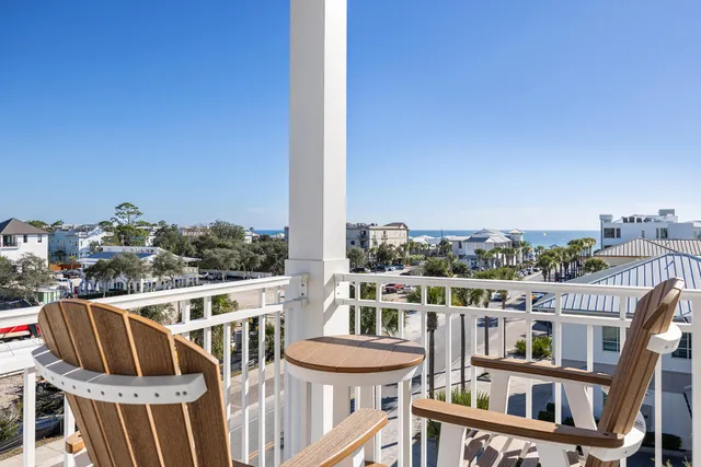 a view of a room with wooden floor and furniture