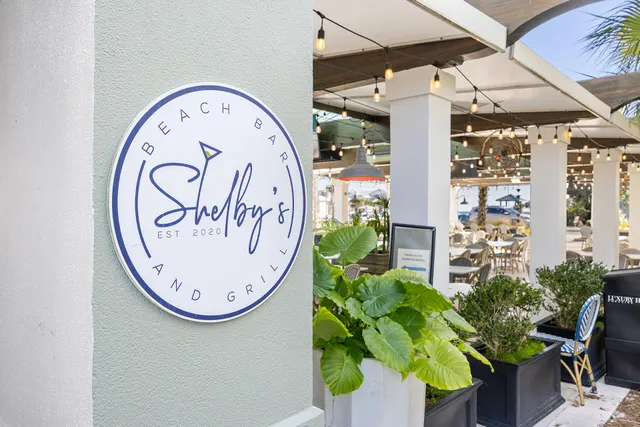 a view of a balcony with wooden floor and furniture