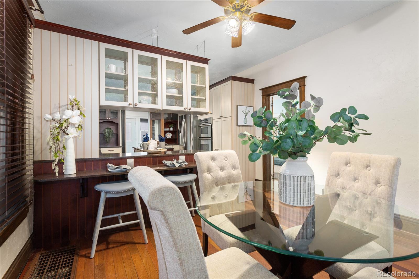 3777 Stuart Street Denver, CO 80212 - Photo 11 of 40 a dining room with furniture a potted plant and a chandelier