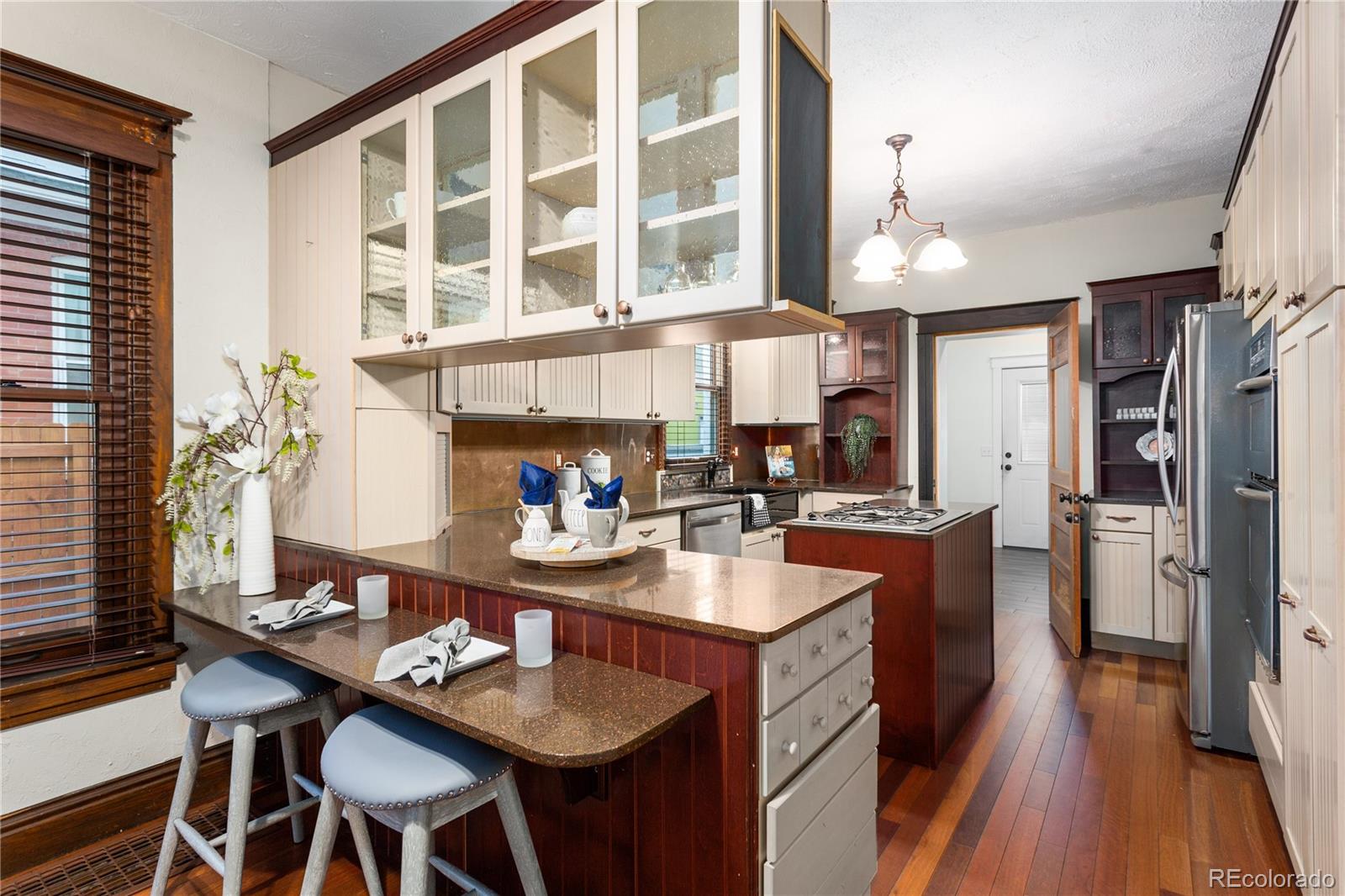 3777 Stuart Street Denver, CO 80212 - Photo 13 of 40 a kitchen with sink refrigerator and cabinets