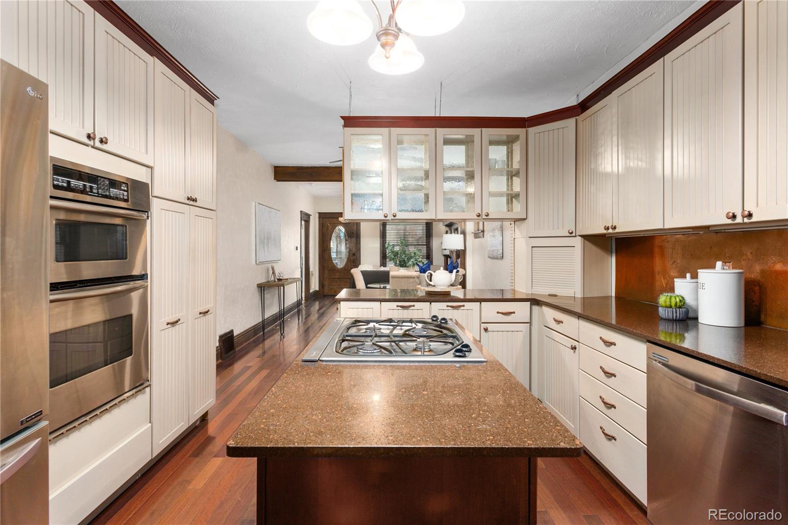 3777 Stuart Street Denver, CO 80212 - Photo 15 of 40 a kitchen with stainless steel appliances granite countertop a stove a sink dishwasher and a refrigerator with wooden floor