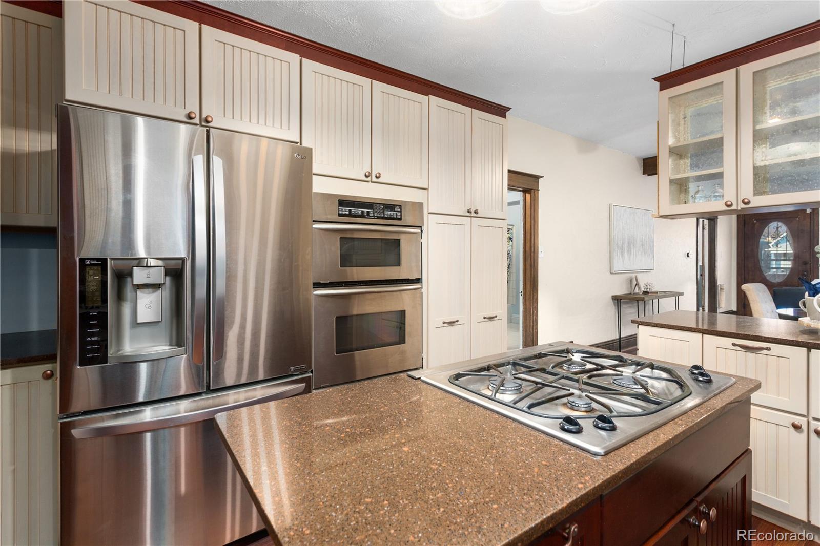 3777 Stuart Street Denver, CO 80212 - Photo 16 of 40 a kitchen with stainless steel appliances a refrigerator stove and microwave