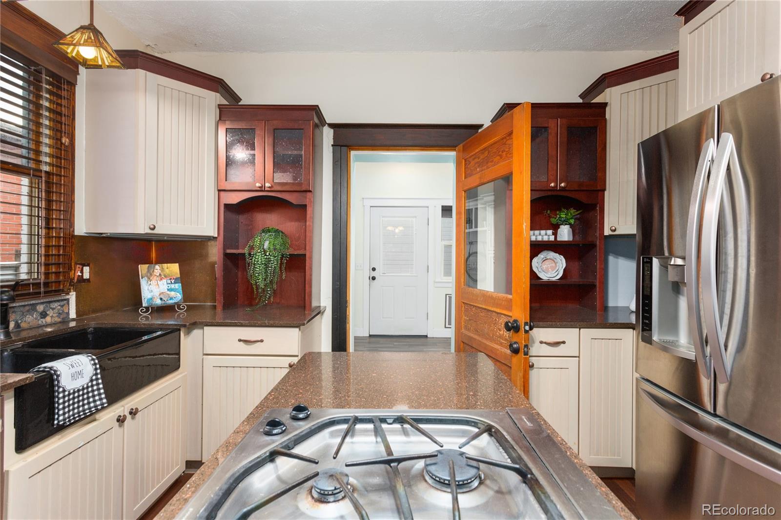 3777 Stuart Street Denver, CO 80212 - Photo 17 of 40 a kitchen with stainless steel appliances a refrigerator sink and microwave