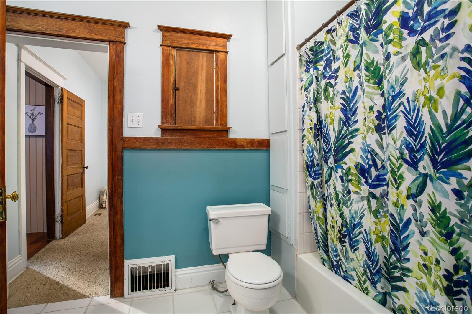 3777 Stuart Street Denver, CO 80212 - Photo 20 of 40 a bathroom with a toilet and a shower curtain