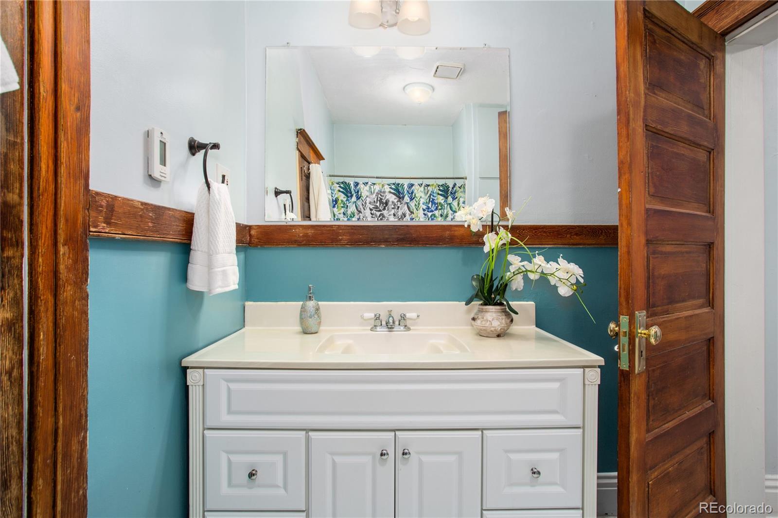 3777 Stuart Street Denver, CO 80212 - Photo 21 of 40 a bathroom with a sink and a mirror