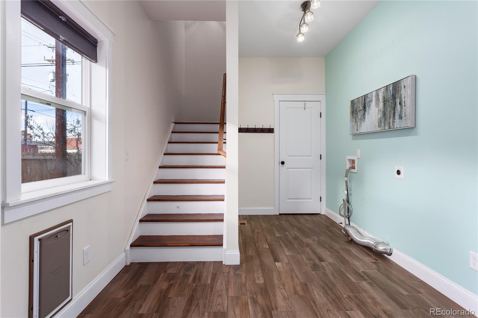 3777 Stuart Street Denver, CO 80212 - Photo 24 of 40 a view of a hallway with wooden floor and windows