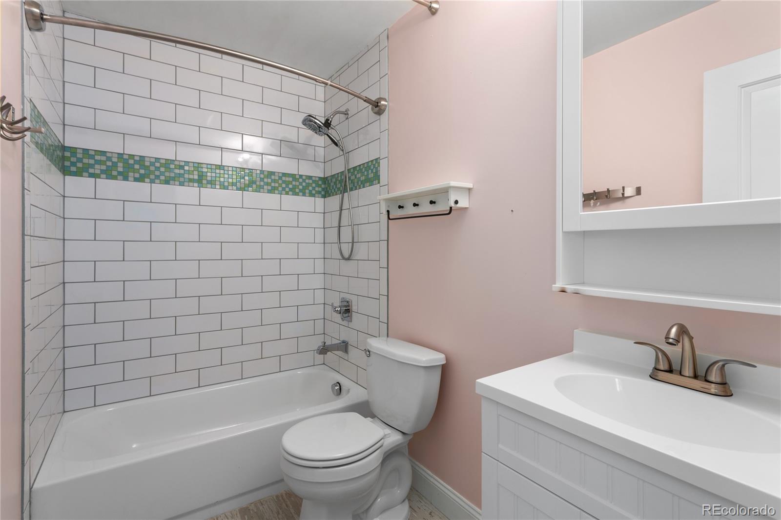 3777 Stuart Street Denver, CO 80212 - Photo 28 of 40 a bathroom with a sink a toilet and shower