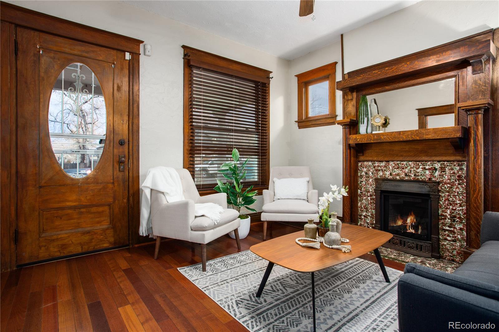 3777 Stuart Street Denver, CO 80212 - Photo 6 of 40 a living room with furniture a rug a fireplace and a large window