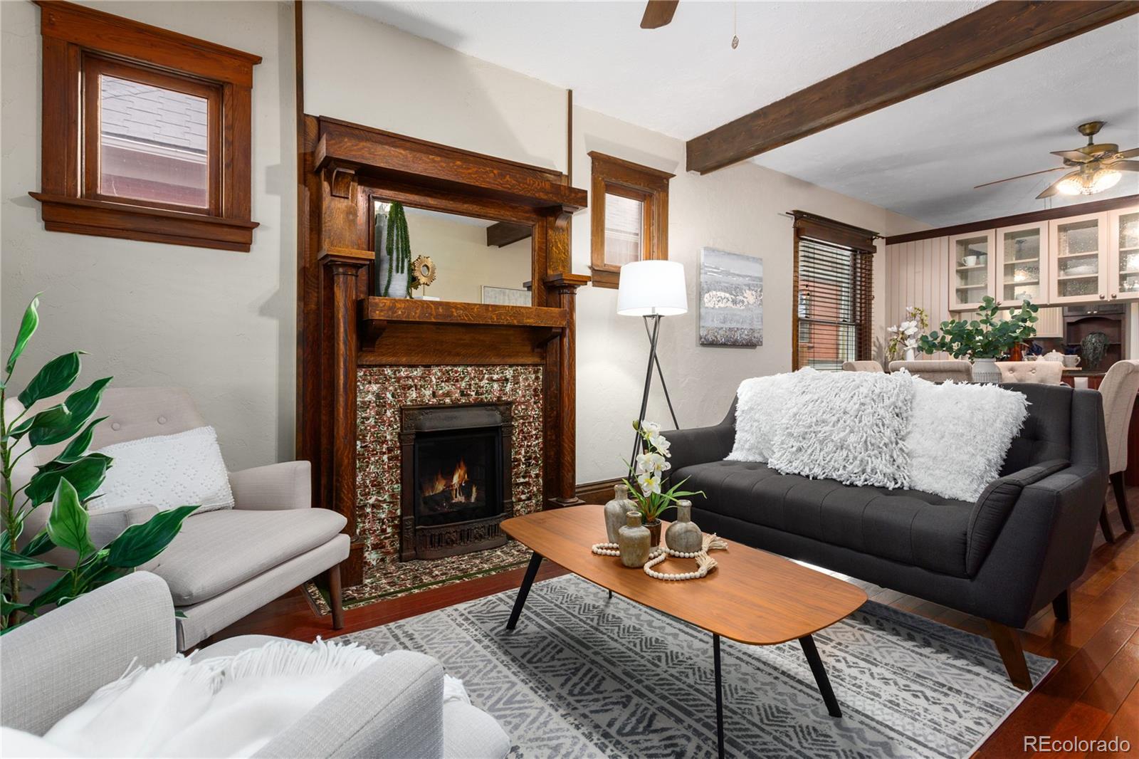 3777 Stuart Street Denver, CO 80212 - Photo 7 of 40 a living room with furniture a large window and a fireplace