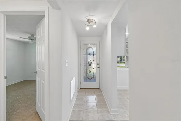 a view of a hallway with wooden shelves
