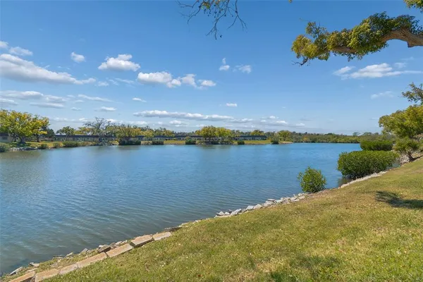 a view of a lake with houses in the background