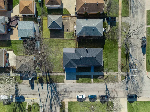 an aerial view of multiple houses with a yard