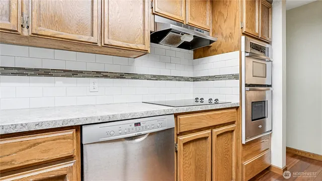 a kitchen with stainless steel appliances granite countertop a sink and a cabinets