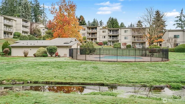 a view of a house with a yard from a lake view