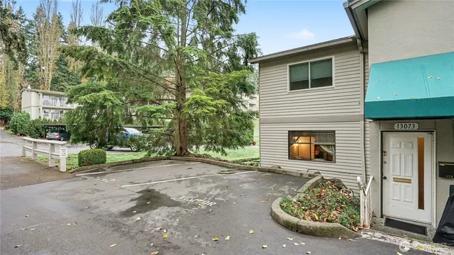 a view of a backyard with table and chairs and a fire pit
