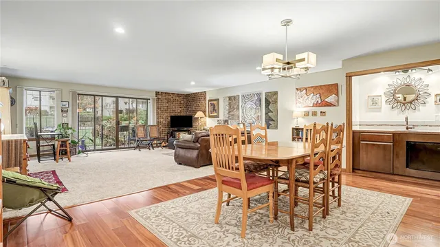 a view of a dining room with furniture wooden floor and chandelier