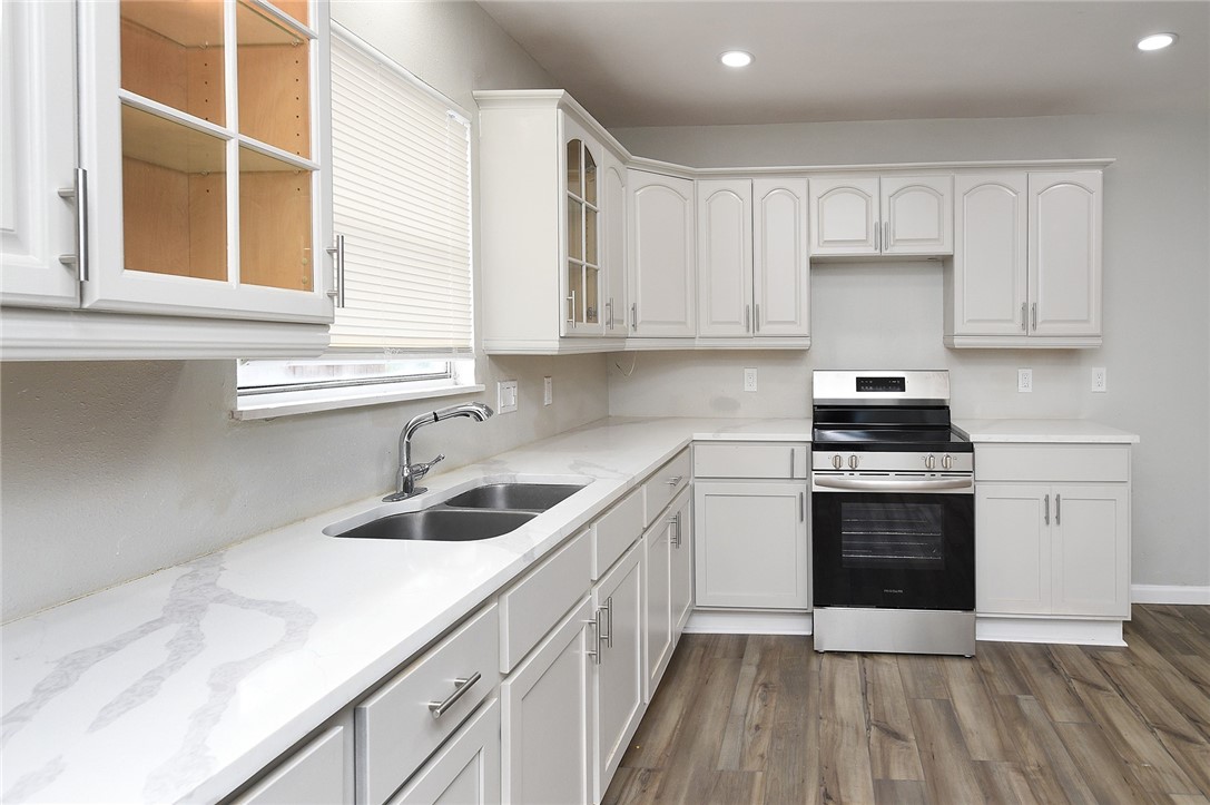 634 Mc Call Street Corpus Christi, TX 78404 - Photo 11 of 34 a kitchen with granite countertop a sink and a stove