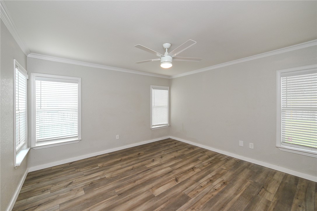 634 Mc Call Street Corpus Christi, TX 78404 - Photo 17 of 34 wooden floor in an empty room with a window