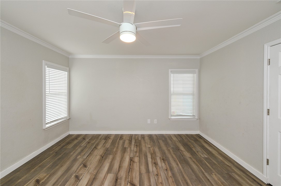 634 Mc Call Street Corpus Christi, TX 78404 - Photo 18 of 34 an empty room with wooden floor and windows
