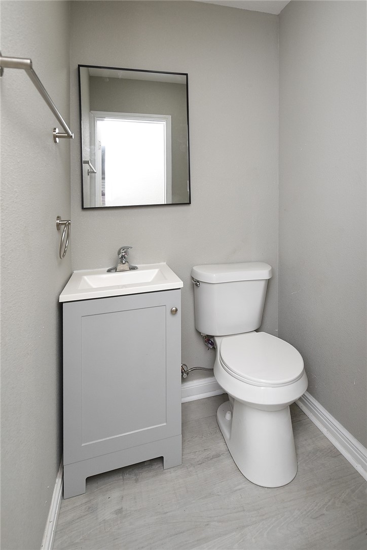 634 Mc Call Street Corpus Christi, TX 78404 - Photo 23 of 34 a bathroom with a toilet sink and mirror