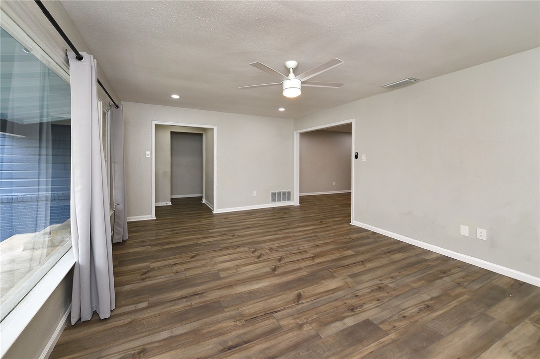 634 Mc Call Street Corpus Christi, TX 78404 - Photo 8 of 34 a view of an empty room with wooden floor and a ceiling fan