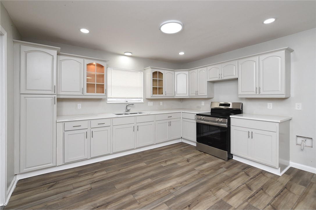 634 Mc Call Street Corpus Christi, TX 78404 - Photo 10 of 34 a kitchen with granite countertop white cabinets and white appliances