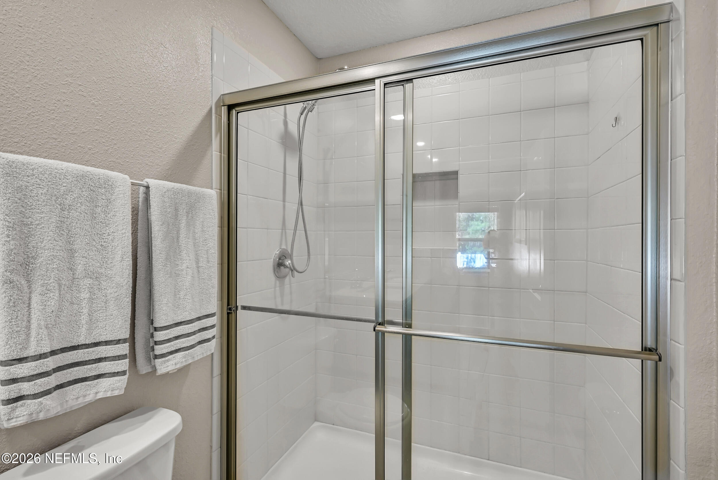532 Bluejack Lane St. Augustine, FL 32095 - Photo 21 of 55 a bathroom with a glass shower door