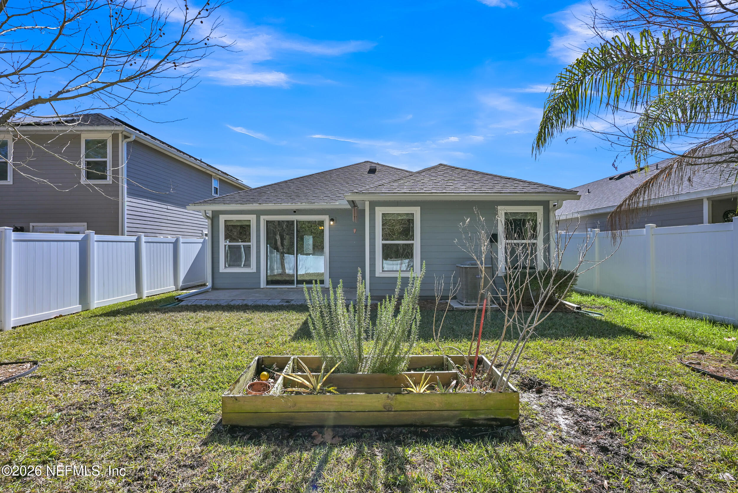 532 Bluejack Lane St. Augustine, FL 32095 - Photo 29 of 55 a front view of a house with a yard table and chairs
