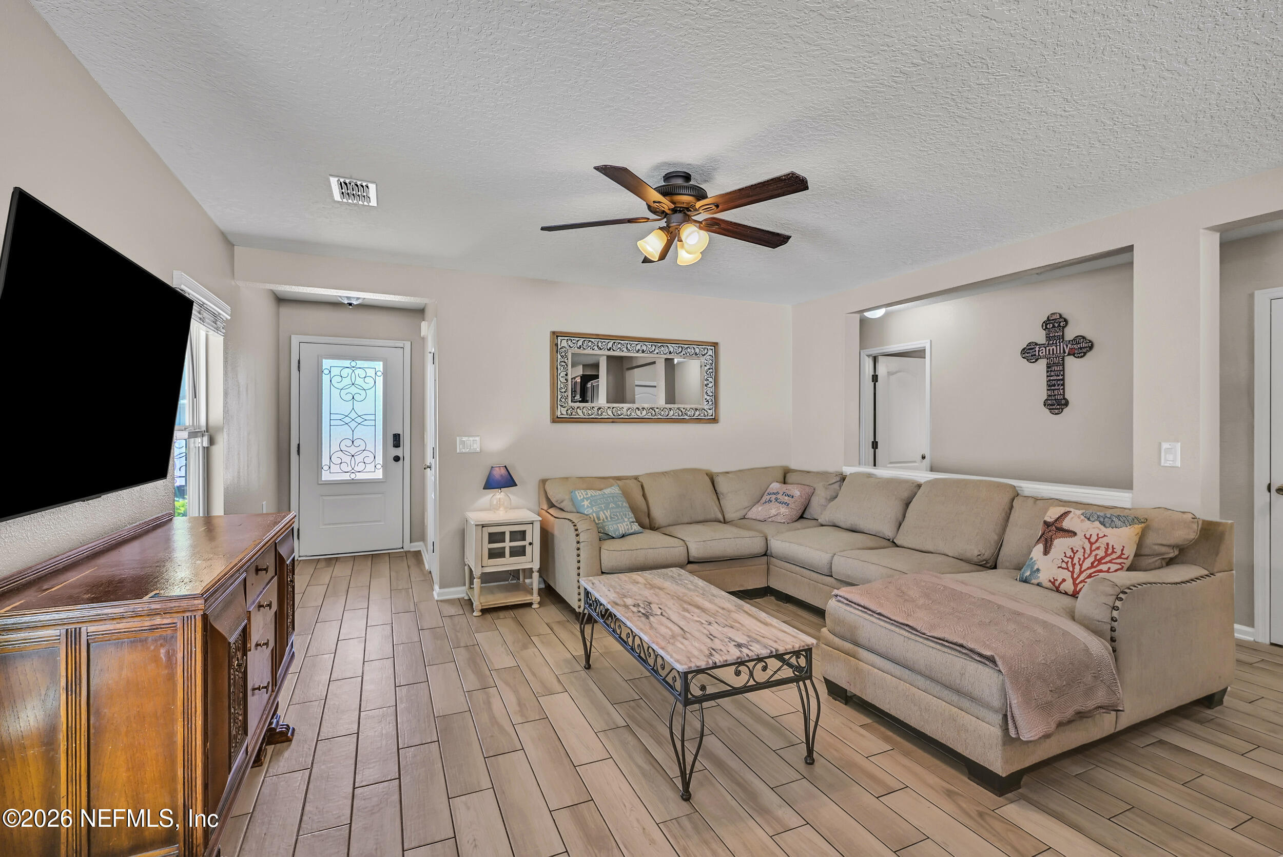 532 Bluejack Lane St. Augustine, FL 32095 - Photo 6 of 55 a living room with furniture and a flat screen tv