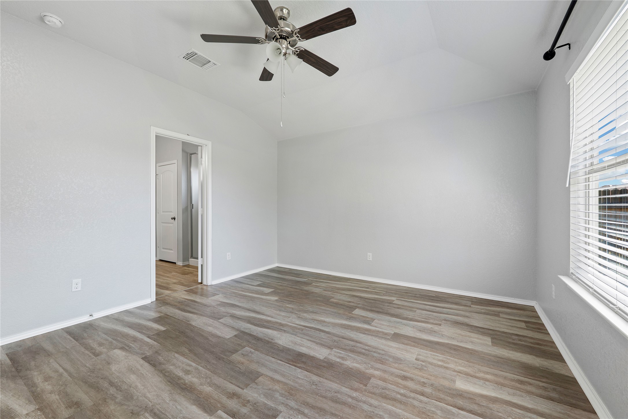 133 Beth Ann Loop Taylor, TX 76574 - Photo 13 of 30 Main bedroom with a ceiling fan, and light dark engineering flooring