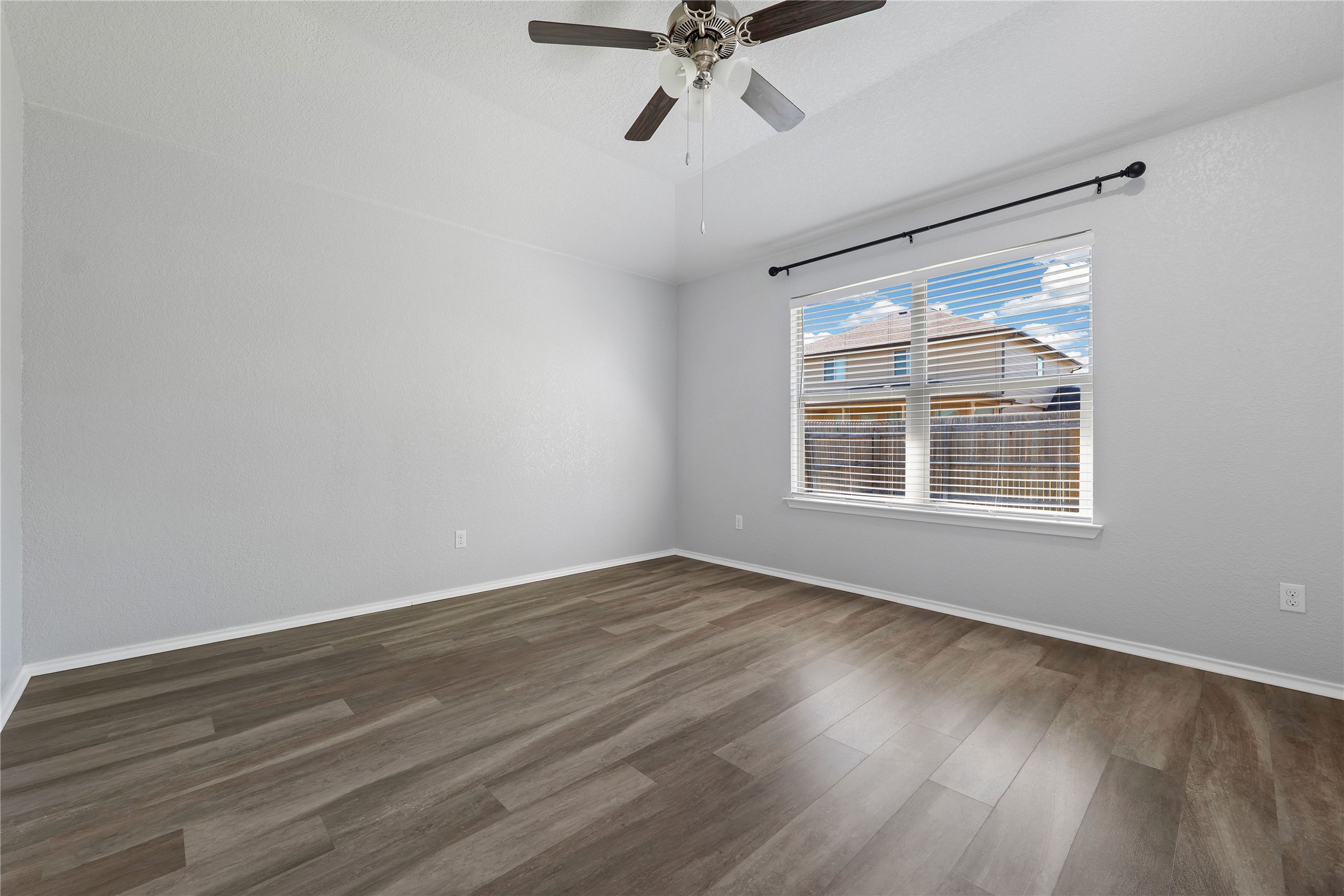 133 Beth Ann Loop Taylor, TX 76574 - Photo 14 of 30 bedroom featuring ceiling fan, dark engineering flooring and lofted ceiling